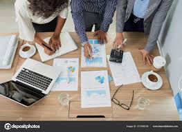 coworkers analyzing charts graphs meeting view stock photo