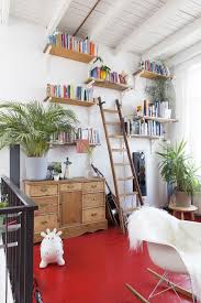 Hardwood floors are great focal points in any room, and pairing them with an appealing paint shade only adds to their appeal. A Home With Red Floors With Surprising Results Red Floor Diy Living Room Decor Red Bookshelf