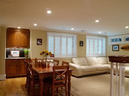 Basement living room with fireplace and brown sofa. Finished Basement Ideas With Open Living And Dining Space With Traditional Furniture U Finished Living Room Finishing Basement Living Room Lighting Low Ceiling