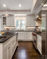 Black And White Kitchen Cabinetry Woodmode Brookhaven With Nordic White Finish Countertops A Replacing Kitchen Countertops Kitchen Renovation Kitchen Design