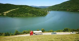 Beneath the beautiful lake of Kosovo are sunken the cemetery of a village and an old church Sign