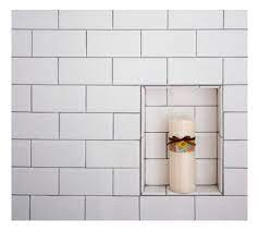 The two shelves slant a hair down and it's on the opposite side of the shower head so it never gets all that wet. Subway Tile Shower Niche 3 8 Higher Than 2nd Niche Noticeable