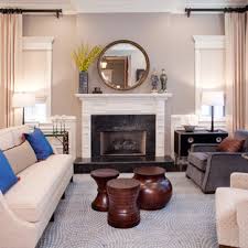 Larger wall mirrors, or smaller ones grouped together, make a room look brighter and bigger. Round Mirror Over Fireplace Houzz