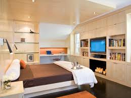 Master bedroom with custom designed bed that swivels to enjoy water views and geometric wood panel walls looks into the master bath area. Modern Bedroom Design Ideas Decor Hgtv