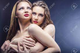Two Beautiful Sexy Lesbians In Each Other's Arms On Black Background Stock  Photo, Picture and Royalty Free Image. Image 68088879.