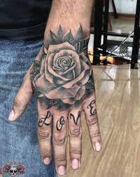 Comme La Setting La Planete Tattoo Est Elle Aussi Regulierement Bouleversee Level P Nouvelles Tendances N Hand Tattoos For Guys Rose Hand Tattoo Rose Tattoos