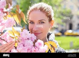 Woman holding branch hi-res stock photography and images