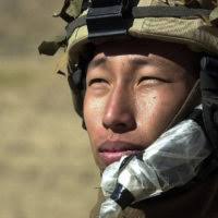 Radio operator, Private First Class (PFC) Thuam Nguyen with "A" Company,  2nd Battalion, 504th Parachute Infantry Regiment (PIR), in the ADI Ghar  mountains during a search for Taliban fighters, in support of Operation  ENDURING FREEDOM