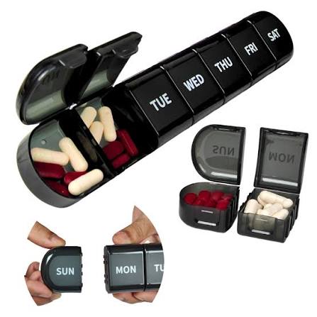 A weekly pill organizer box divided by day, used to sort daily medications