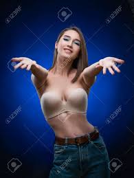 Beautiful Mixed Race Asian Girl With Big Breasts, Wearing A Bra And Jeans,  Smiles And Holds Out Her Hands Forward. Advertising, Commercial Design  Stock Photo, Picture and Royalty Free Image. Image 134595364.