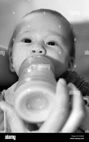 Bottle feeding Black and White Stock Photos & Images