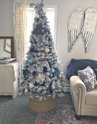 Navy, silver and gold christmas tree for a modern, bold and untraditional look, consider a navy, silver and gold christmas tree decorations like this one by tamara of citrine living. Elegant Flocked Christmas Tree With Blue And Silver Decorations