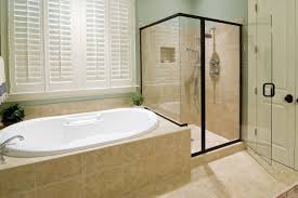 A sleek window and cubby are features that are built into the shower wall and the double waterfall style shower head gives the primary bath a modern square touch. How Much Do Bathroom Remodels Cost Tundraland