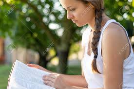 Christian Worship And Praise. A Young Woman Is Reading The Bible ...