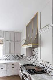 If you like the look, go for it! Steel And Brass Kitchen Hood With White Shaker Cabinets Transitional Kitchen
