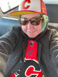 I'm Flamed up to cheer for the Eagles for the Gaudreau brothers 💙💚 My  jersey and hat are signed by Theo Fleury! It's a Mony jersey❤️🧡
