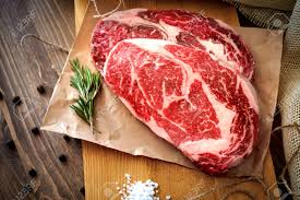 This cut of steak comes from the ribs of the animal, right between the loin and shoulder. Two Raw Rib Eye Steak On A Wooden Board On A Table Prepared For The Grill Top View Rustic Style Stock Photo Picture And Royalty Free Image Image 123491476