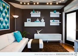 Dining area featuring a blue wall with a brown accent, along with a square dining table paired with white chairs. 15 Interesting Combination Of Brown And Blue Living Rooms Home Design Lover Brown And Blue Living Room Brown Living Room Blue Living Room