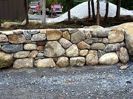 Using mortar to build a stone wall holds the wall together and prevents the stones from shifting. Round Stone Mortar Wall Rock Wall Landscape Dry Stone Wall Stone Masonry