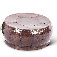 Offering an artful look that's ideal for staging centerpieces and serving up cocktail party uncompromising quality, beauty, and functionality make up this premier hammered copper round coffee table. Round Antique Copper Coffee Table Kirklands