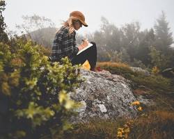 Image of solo traveler journaling