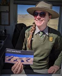 A Park Ranger Greets Visitors And Offers A Park Map From Inside The Entrance Station At Great Sand Dunes Na In 2020 Sand Dunes National Park National Parks Park Ranger