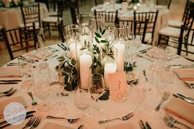 Various Height Pillar Candles Grouped As A Centerpiece With Greenery Throu Candle Wedding Centerpieces Pillar Candles Wedding Pillar Candle Centerpiece Wedding