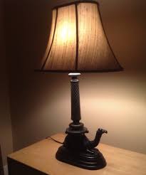 Antique design for a tiny table lamp with a frame and stand made out of copper metal with a shiny, high polish finish. My Mystery Camel Lamps Collectors Weekly