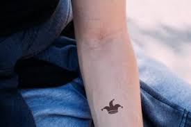 Evil joker tattoo designs best tattoo ideas. Jester Tattoos Lovetoknow