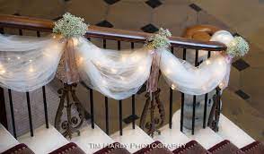 When done properly, the result will be festive but not gaudy and complement the room's decor and other decorations. Tulle Lights And Baby S Breath Staircase Decorations Peas In A Pod Tulle Wedding Decorations Wedding Decorations Wedding Staircase