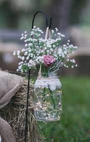 2 Hanging Mason Jars With Led Lights And Blush Roses And Babys Breath Hanging From A Garden Stand For The E Mason Jar Wedding Wedding Aisle Wedding Decorations