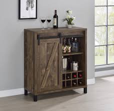 A rustic style buffet of barn wood with a worn brown finish outside and in lighter browns inside. Rustic Farmhouse Ii Bar Cabinet With Wine Storage