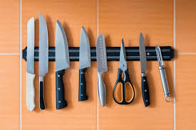 The clever diy folks at instructables detail how to make your own magnetic knife block to hold your knives on the wall for easy access. Knives Hang On A Magnet Holder Orange Kitchen Wall Stock Photo Image Of Sharp Collection 127961016