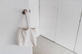 But then while i was researching this post for you guys, i discovered that you can do some totally incredible things with plain tote bags. Shopping And Daily Life Plain White Canvas Tote Bag Handging On Door Knob In Front Of Wardrobe Doors With Minimalist Look Stock Photo Image Of Canvas Cupboard 173177832