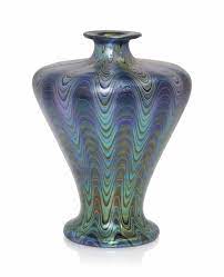 Use the top of each vase as a bud vase as the unique shape allows you to place it at an angle. A Loetz Iridescent Glass Vase