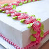 To find the cake serving size area, multiply the length and width of the cake slice. 1