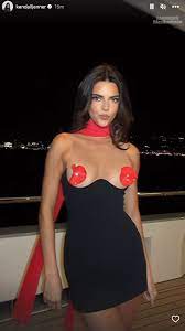 Kendall Jenner goes topless except for tiny red flower pasties in raunchy  new videos on yacht with Bad Bunny in France | The US Sun