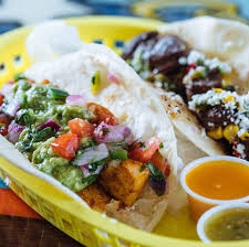 Beer battered cod are the star of these fresh and tasty fish tacos, served in corn tortillas with shredded cabbage and a zesty white sauce. Mojo Fish Left Cowboy Right E1556809703474 Tlm
