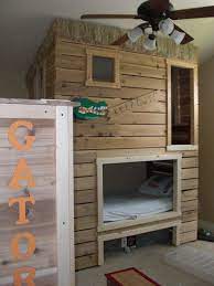 Create a theme for the room by using the loft bed as a centerpiece. Bunk Bed Fort Minus The Gator Stuff If I Could Get My Husband To Do This It Would Be Awesome Bed Fort House Beds For Kids Kid Beds