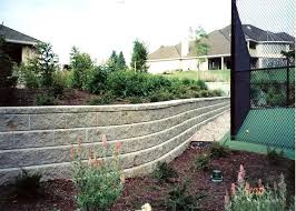 Concrete block retaining wall construction consists of number of phases including excavation, foundation soil preparation, retaining wall base construction, concrete block unit placement, grouting and drainage system installation. Retaining Wall Blocks Landscaping Network