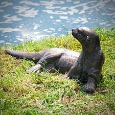 Adorable river otter on his back after a flip turn. Otter Garden Ornament Garden Ornaments Otters Garden Statues