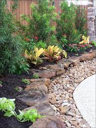 Rock garden designs front yard with flower bed and green grass plus potted plants. 20 Stunning Front Yard Courtyard Landscaping Ideas Coodecor Rock Garden Landscaping Front Yard Landscaping Landscaping With Rocks