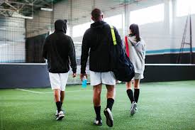 How many players on an in side soccer field? Back View Of Soccer Players In Football Field By Bonninstudio Football Field