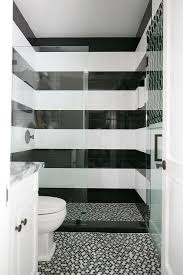 Black And White Shower Tile Black And White Striped Shower Surround Tiles Are Fitted With An Oil Rubbed Bronze Shower Kit Fixed White Tile Shower Black Tile Bathrooms Shower Tile Designs