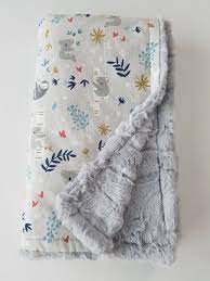 The dyes which are used to color the minky blankets tend to leech if it is washed in warm or very hot water. Gray Koala And Sloth Print Minky Baby Blanket Etsy Minky Baby Blanket Baby Boy Blankets Printed Baby Blanket