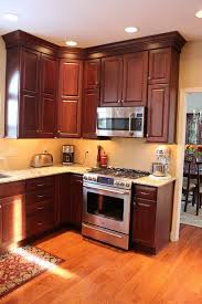 A Remodeled Kitchen In Doylestown Pennsylvania Now Has Sparkly Accents Of Glass And Elegant Crown Mouldin Kitchen Cabinets In Bathroom Brown Kitchens Kitchen