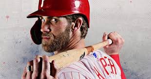Bryce Harper of the Philadelphia Phillies reacts after hitting a solo...