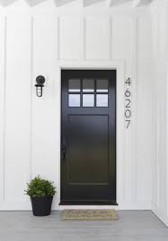 Glossy Black Front Door Contrasting Against White Panels Lincthelendesign Modern Farmhouse Exterior Painted Front Doors Farmhouse Exterior