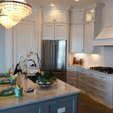 Grey kitchen cabinets with grey backsplash and a white island counter. Expect To See More Of These Kitchen Cabinet Trends In 2018 Florida Design Works