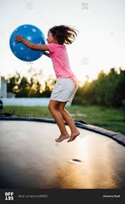 Looking for the closest sky high sports trampoline park & family entertainment center? Girl Holding Ball Jumping High On Trampoline Stock Photo Offset Trampoline Photo Photoshoot
